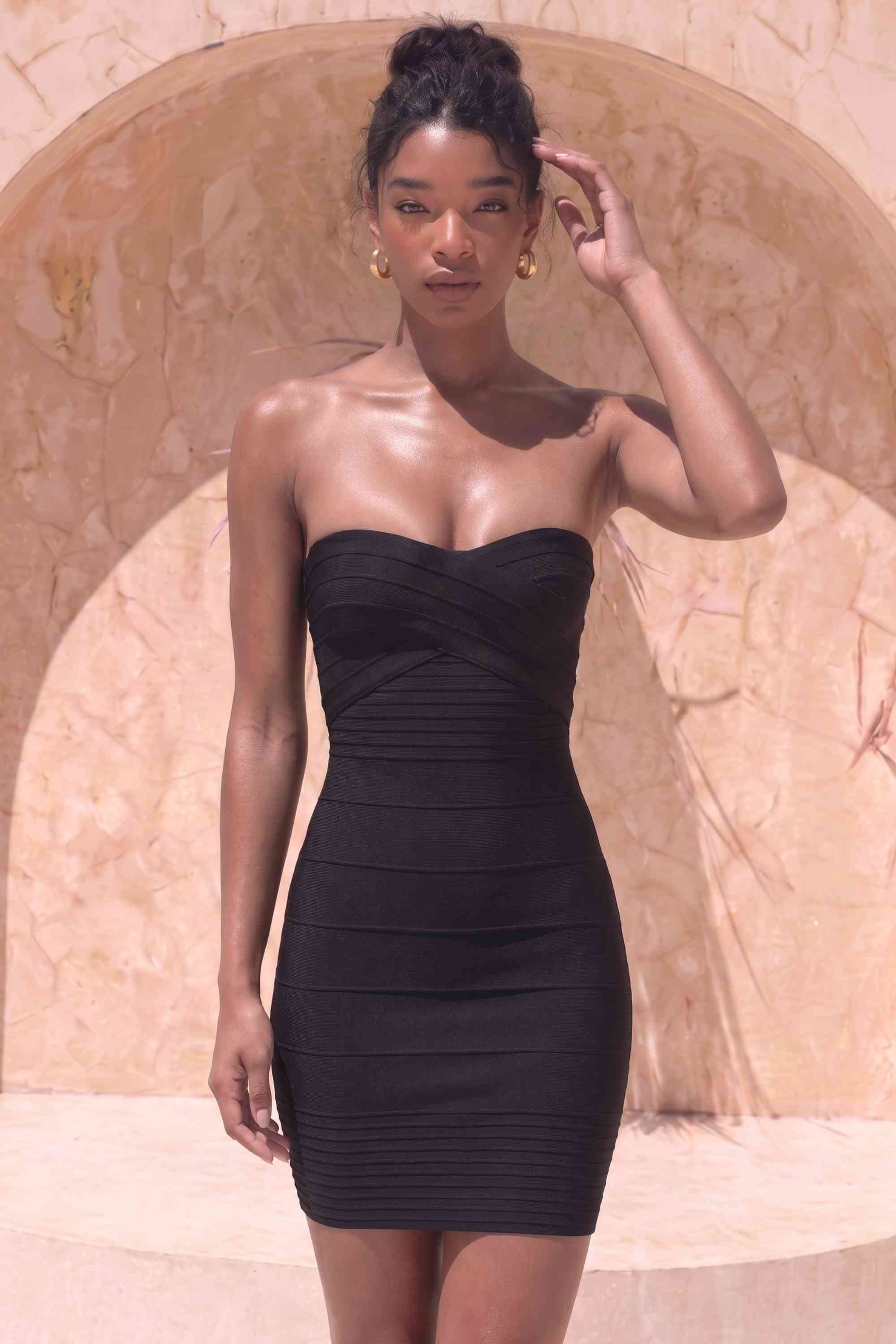 Woman wearing a figure flattering Aaliyah Bandage Mini Dress - Classic Black BODYCON COLLECTION