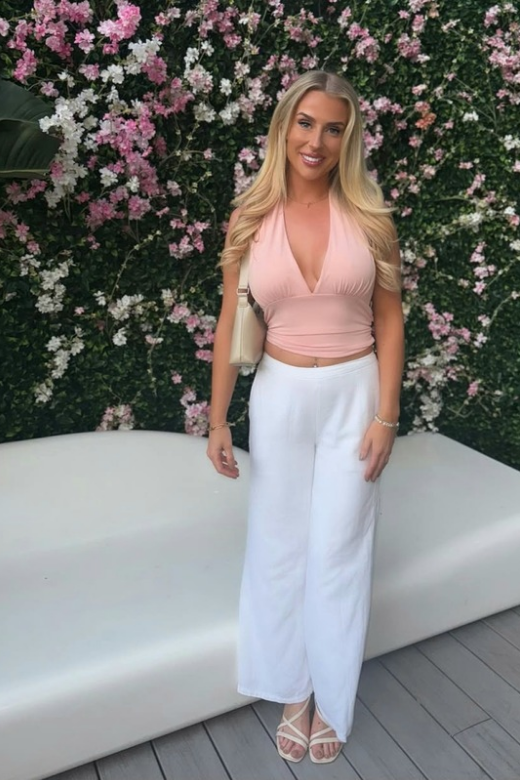 Woman wearing a figure flattering Aby Halter Top - Pink Peach Fuzz BODYCON COLLECTION Pty Ltd