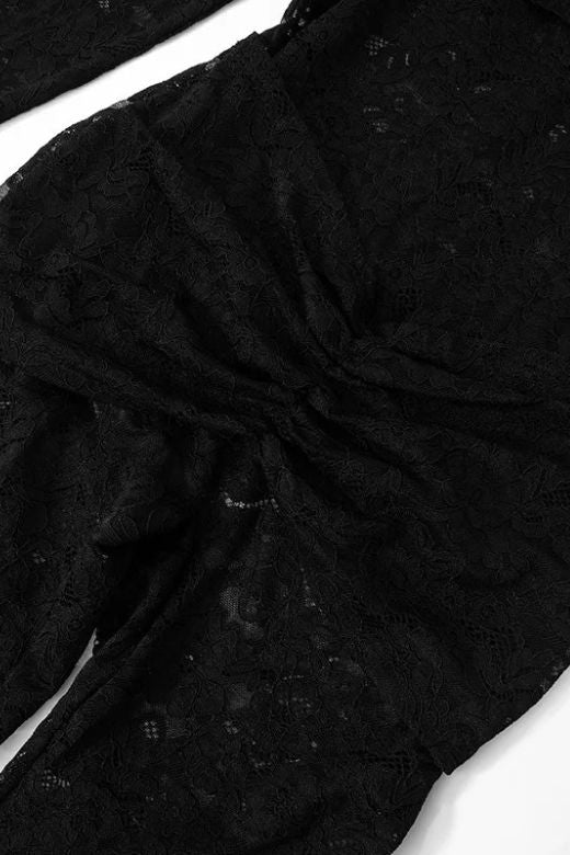 Woman wearing a figure flattering Andie Long Sleeve Bodycon Wrap Jumpsuit - Classic Black BODYCON COLLECTION