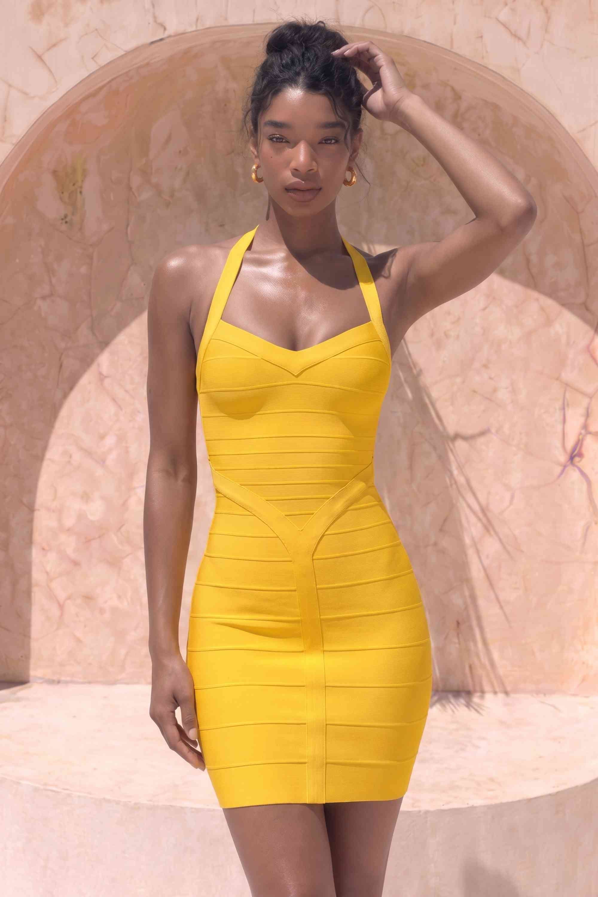 Woman wearing a figure flattering Athena Bandage Mini Dress - Mustard Yellow BODYCON COLLECTION Pty Ltd