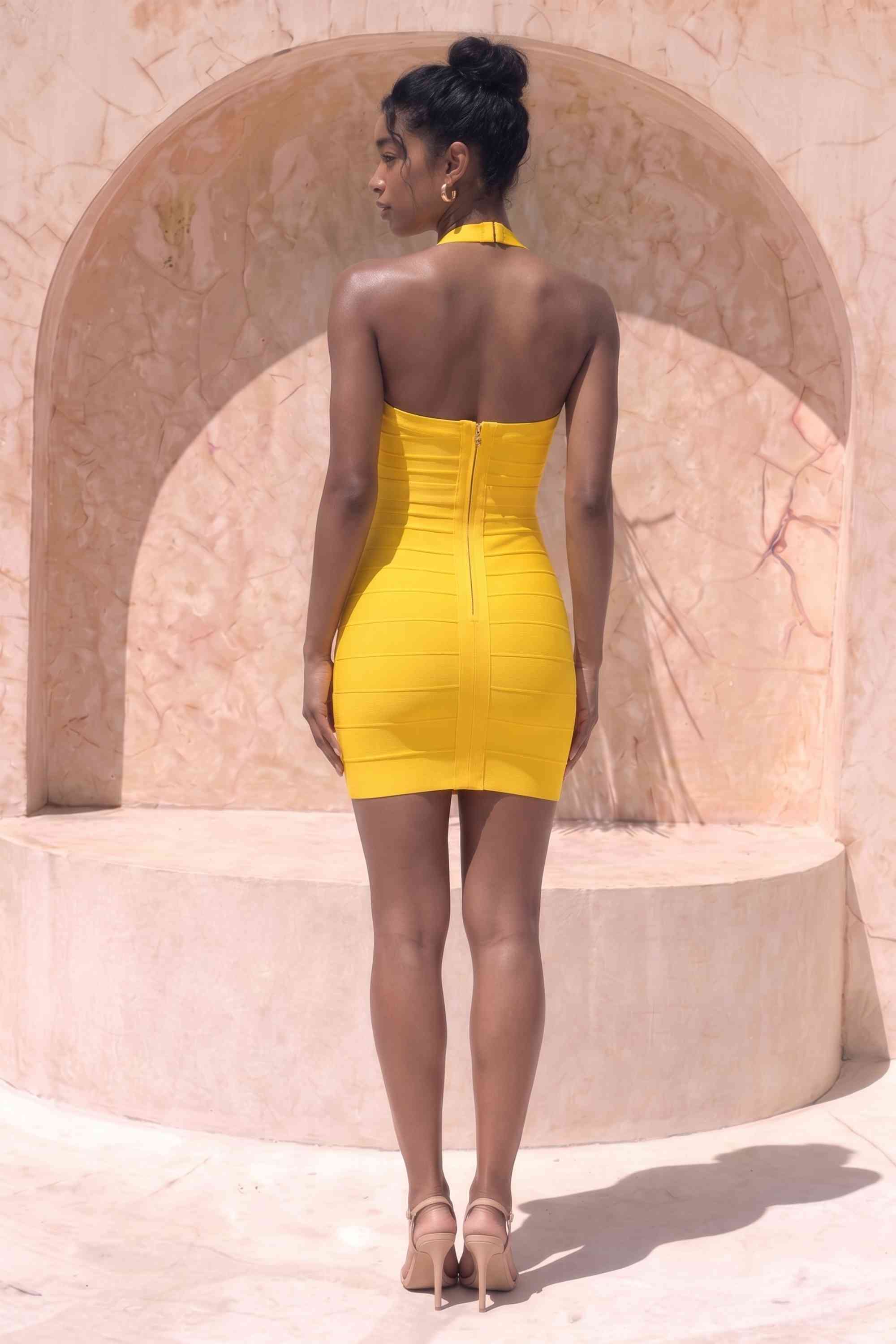 Woman wearing a figure flattering Athena Bandage Mini Dress - Mustard Yellow BODYCON COLLECTION Pty Ltd