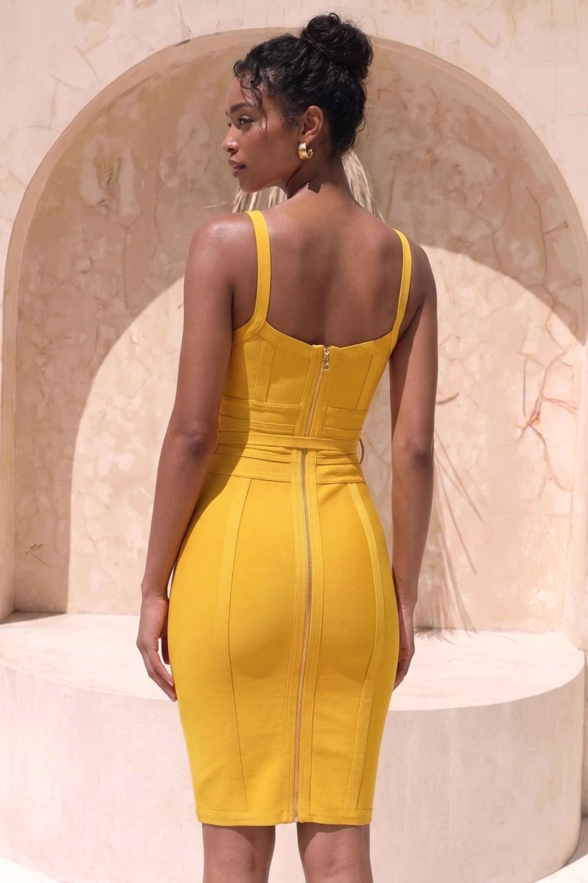 Woman wearing a figure flattering Bek Bandage Dress - Mustard Yellow Bodycon Collection