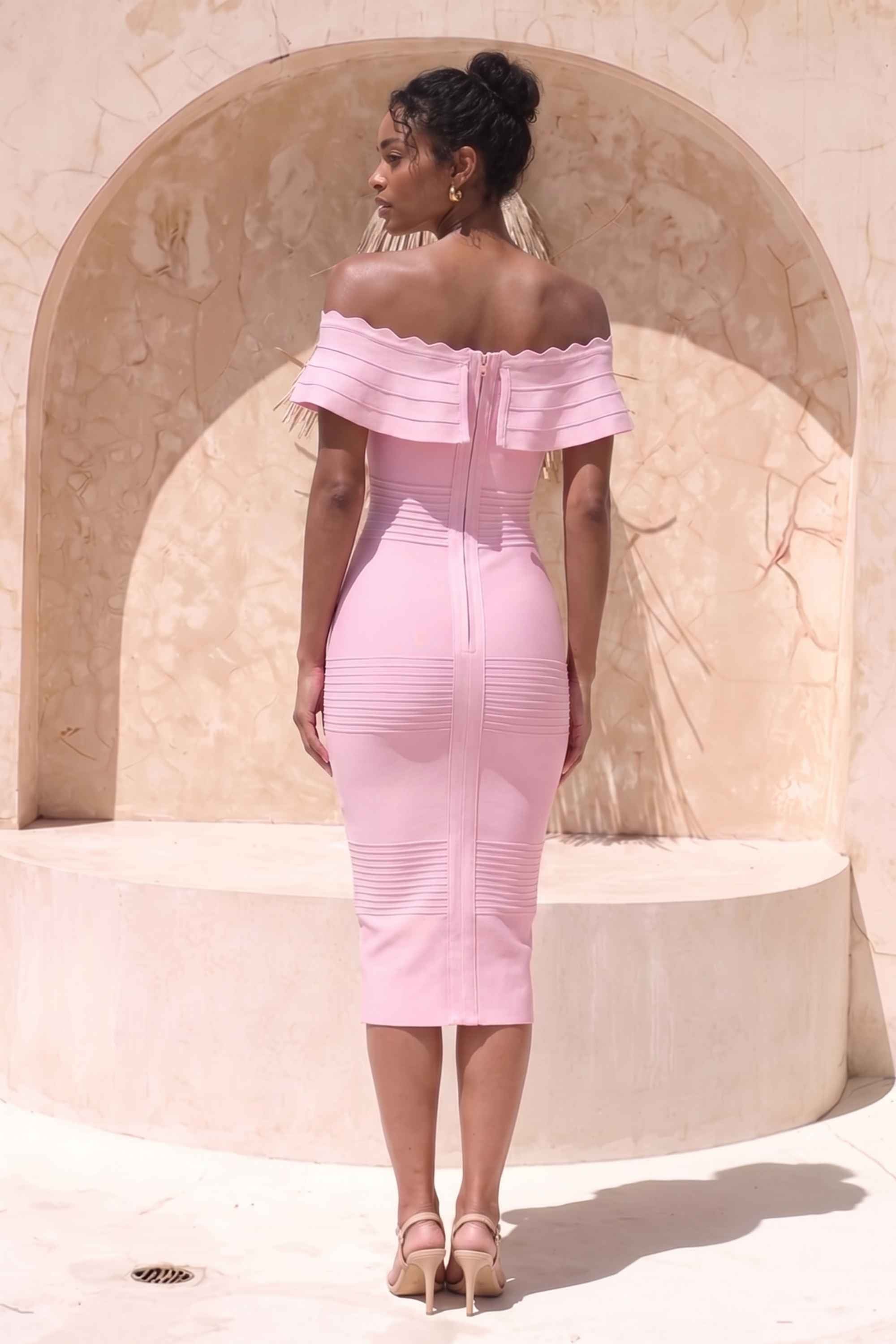 Woman wearing a figure flattering Billie Bandage Midi Dress - Dusty Pink Bodycon Collection