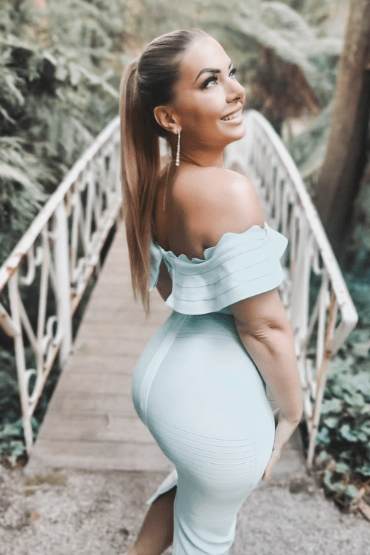 Woman wearing a figure flattering Billie Bandage Midi Dress - Mint Green Bodycon Collection