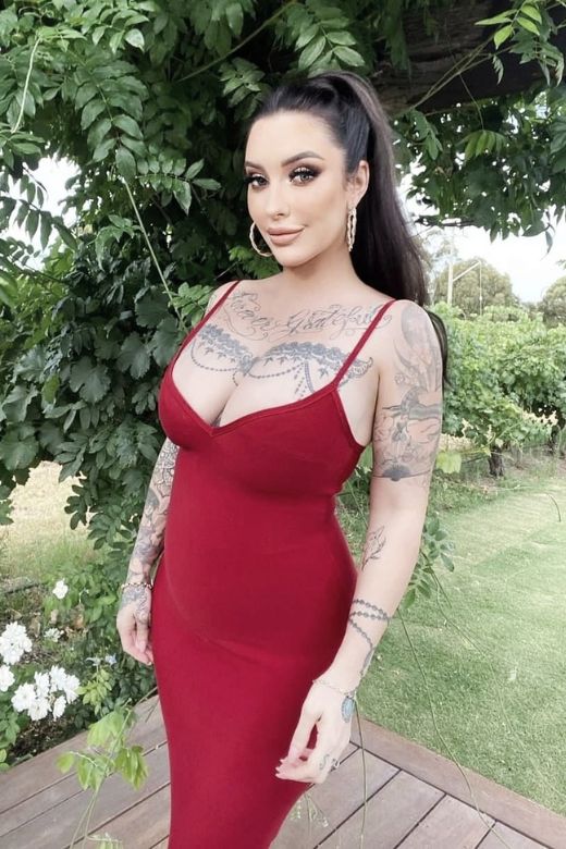 Woman wearing a figure flattering Blanche Bandage Midi Dress - Pearl White BODYCON COLLECTION