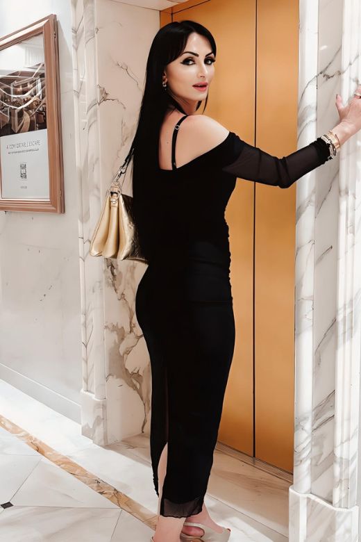 Woman wearing a figure flattering Brianna Bodycon Long Sleeve Maxi Dress - Classic Black BODYCON COLLECTION