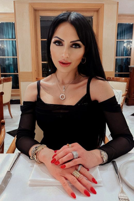 Woman wearing a figure flattering Brianna Bodycon Long Sleeve Maxi Dress - White Pearl BODYCON COLLECTION