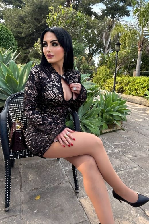 Woman wearing a figure flattering Charlotte Long Sleeve Bodycon Mini Dress - Classic Black BODYCON COLLECTION