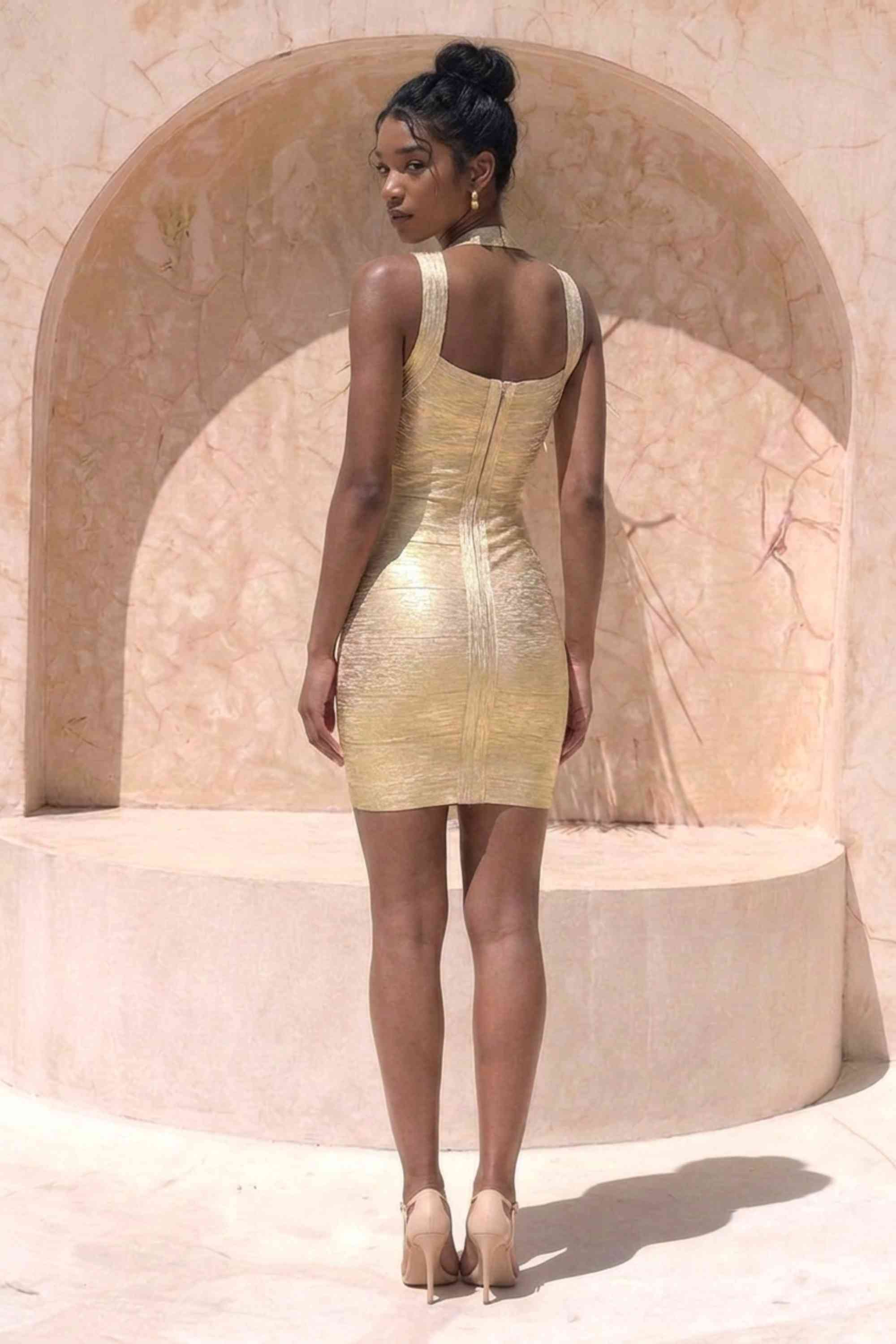 Woman wearing a figure flattering Ciara Bandage Mini Dress - Gold BODYCON COLLECTION
