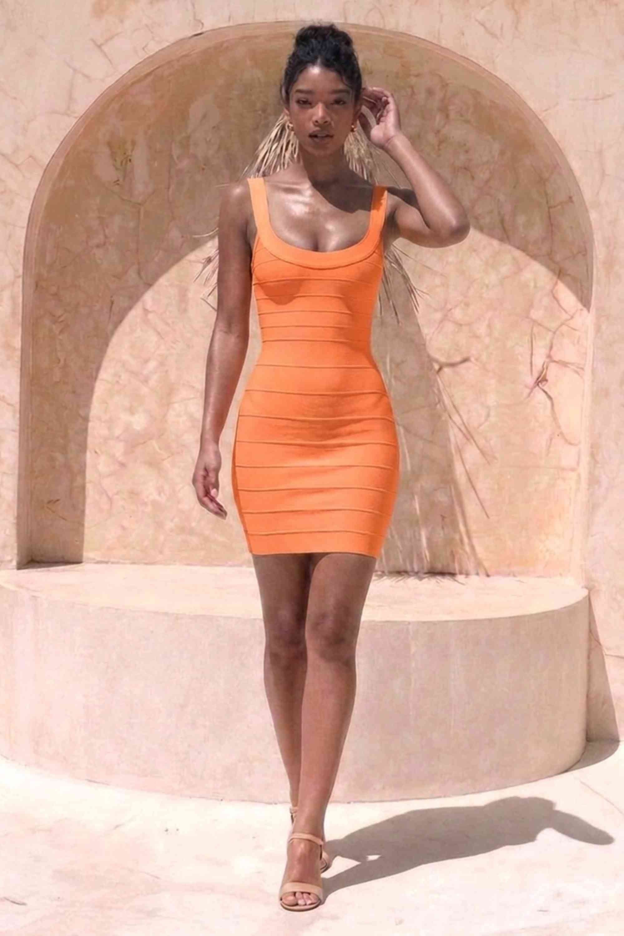 Woman wearing a figure flattering Cindy Bandage Mini Dress - Apricot Orange BODYCON COLLECTION Pty Ltd