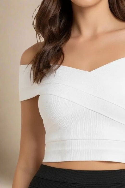 Woman wearing a figure flattering Cindy Bandage Off Shoulder Crop Top - White Pearl BODYCON COLLECTION