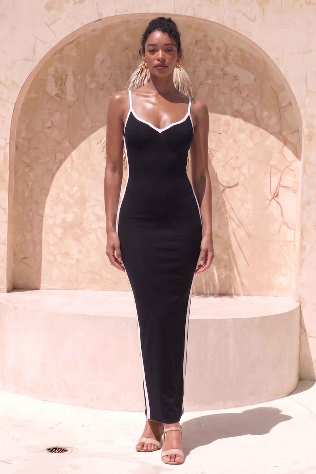 Woman wearing a figure flattering Dianne Bandage Maxi Dress - Classic Black BODYCON COLLECTION