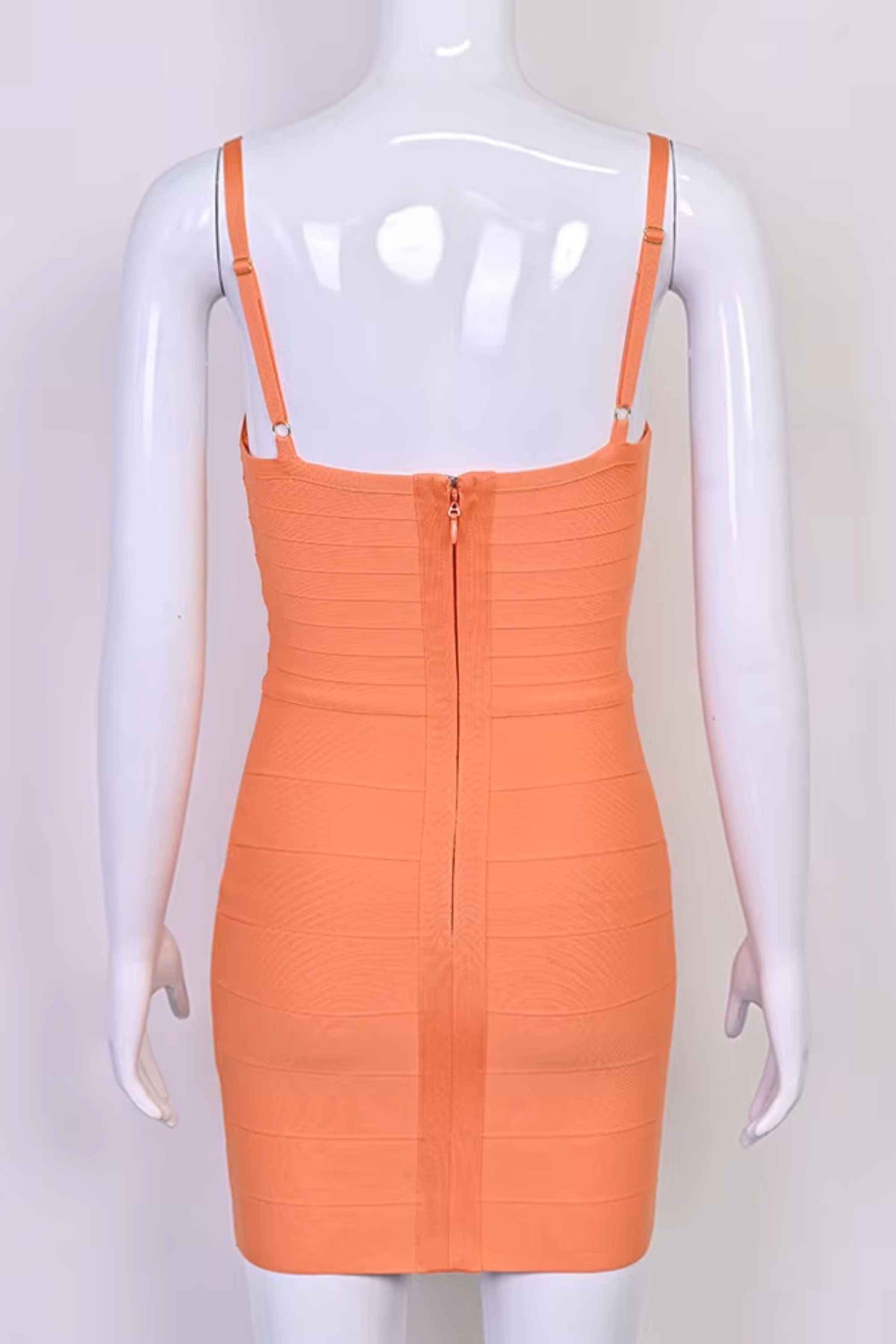 Woman wearing a figure flattering Dom Bandage Mini Dress - Coral BODYCON COLLECTION Pty Ltd