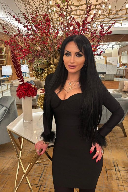 Woman wearing a figure flattering Erin Long Sleeve Bandage Mini Dress - Classic Black BODYCON COLLECTION