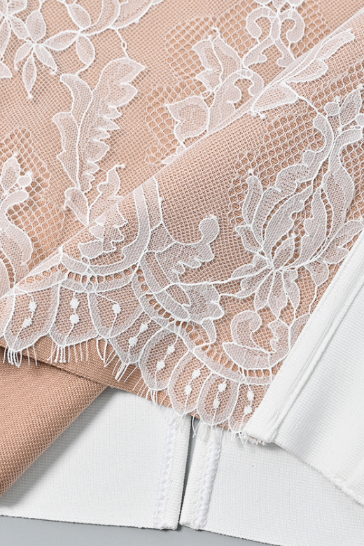 Woman wearing a figure flattering Genevieve Bodycon Lace Midi Dress - White Pearl BODYCON COLLECTION