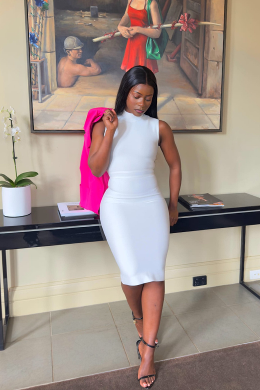 Woman wearing a figure flattering Grace Bandage Midi Dress - White Pearl Bodycon Collection