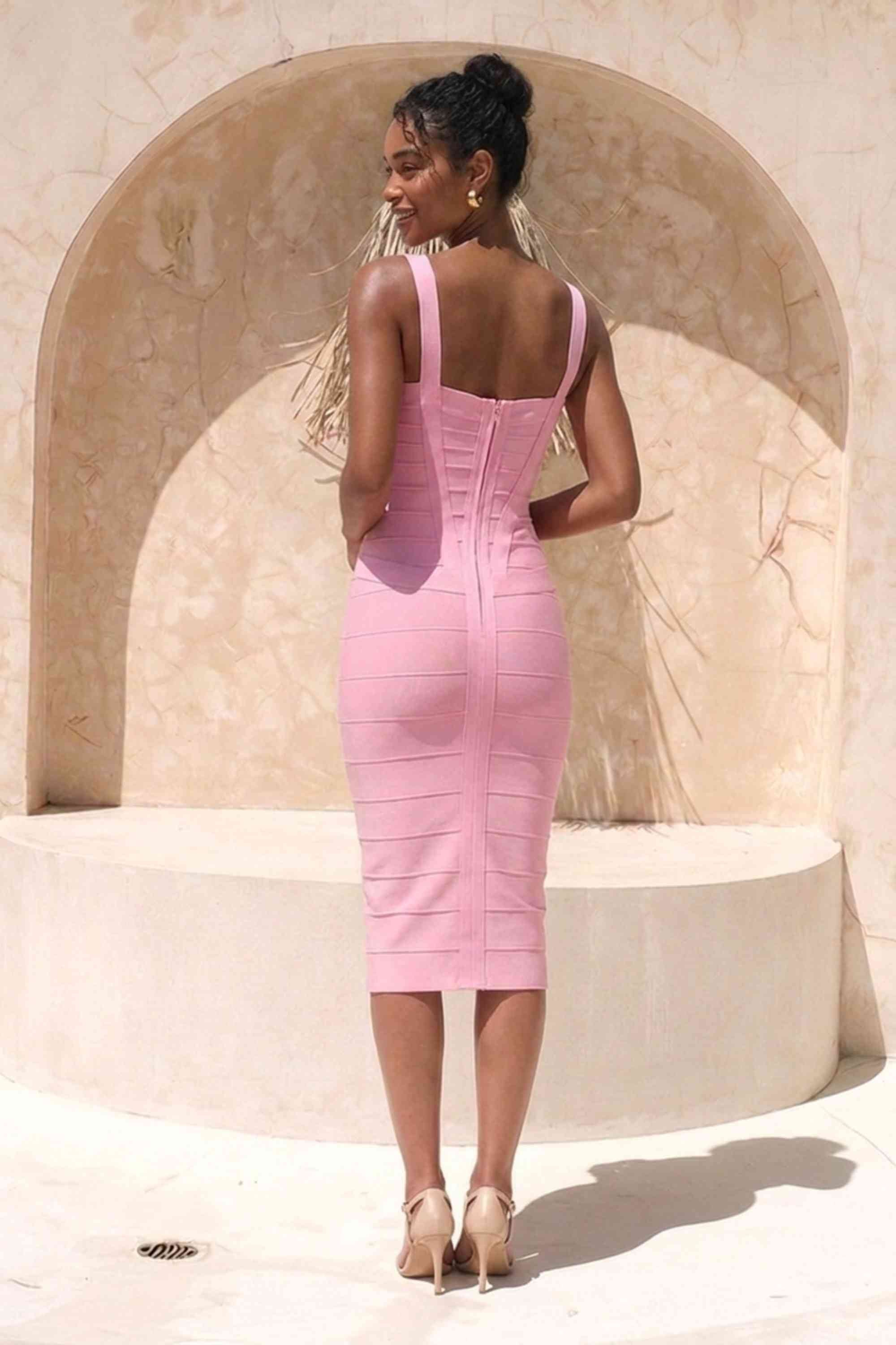 Woman wearing a figure flattering dusty pink party dress Heidi Bandage Midi Dress - Dusty Pink Bodycon Collection