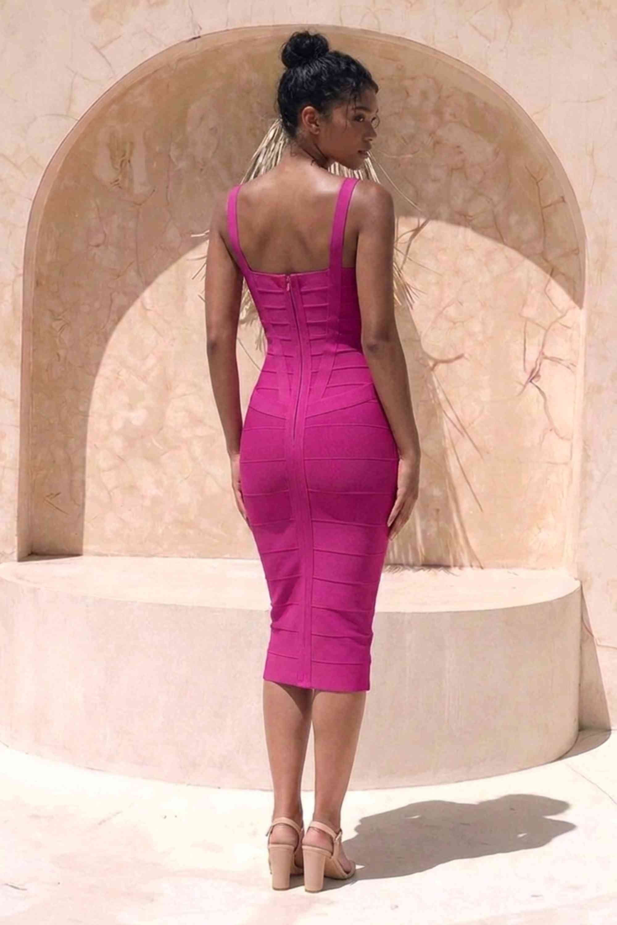 Woman wearing a figure flattering magenta pink party dress Heidi Bandage Midi Dress - Magenta Pink Bodycon Collection