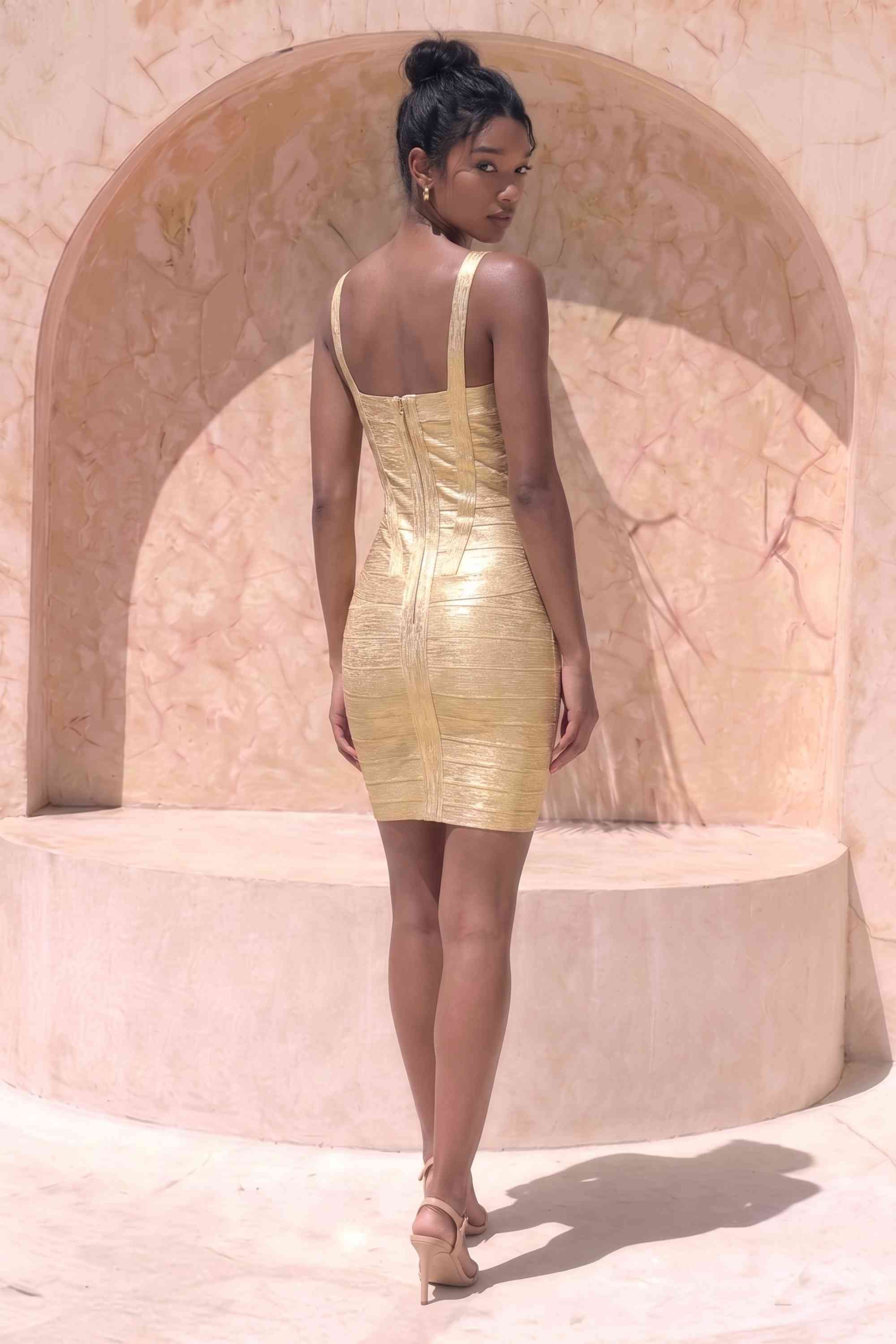 Woman wearing a figure flattering Heidi Bandage Mini Dress - Gold Bodycon Collection
