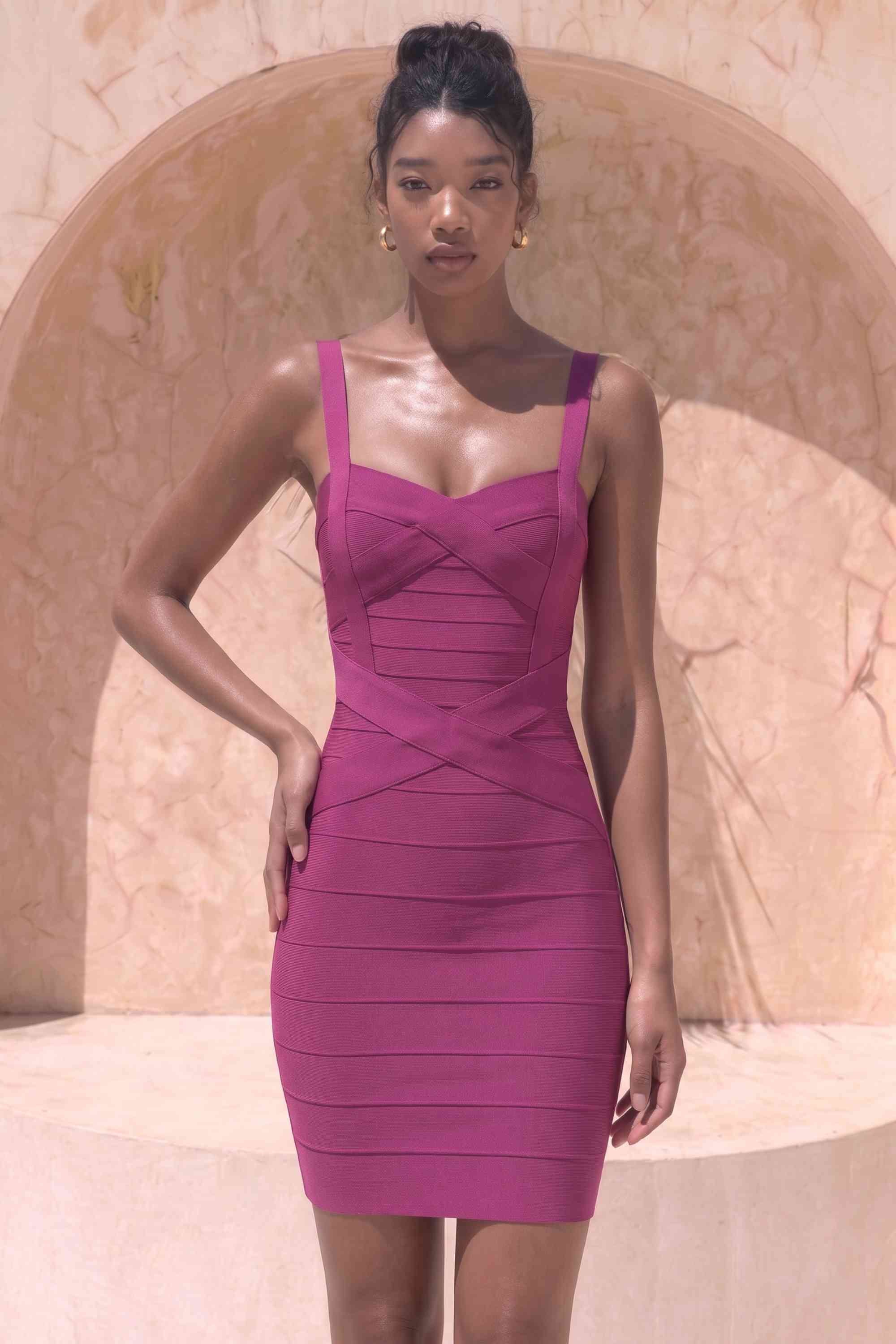 Woman wearing a figure flattering Heidi Bandage Mini Dress - Magenta Pink Bodycon Collection
