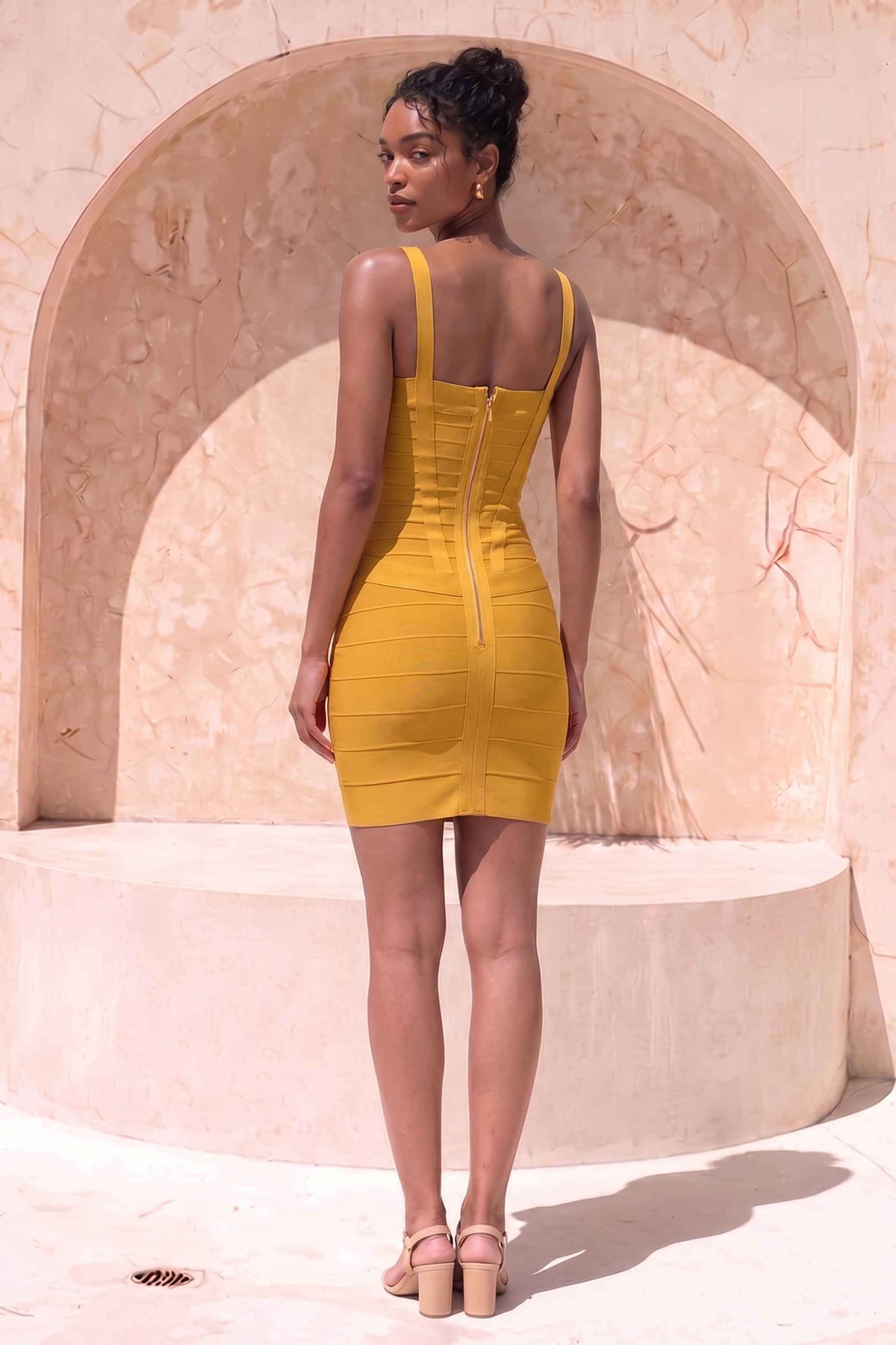 Woman wearing a figure flattering Heidi Bandage Mini Dress - Mustard Yellow Bodycon Collection