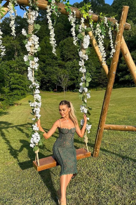 Woman wearing a figure flattering Honor Bodycon Midi Dress - Emerald Green BODYCON COLLECTION