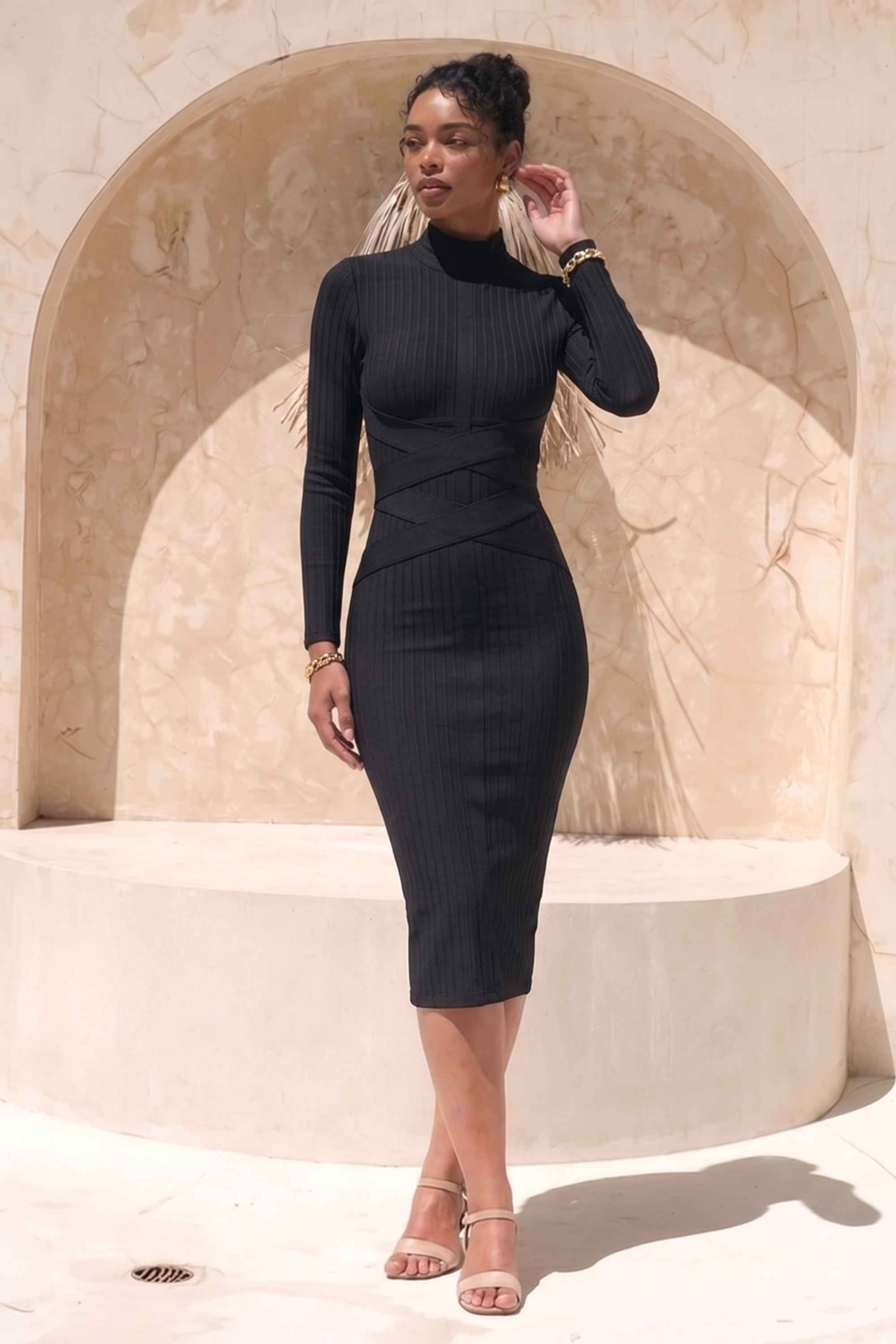 Woman wearing a figure flattering Jane Long Sleeve Bodycon Midi Dress - Classic Black Bodycon Collection