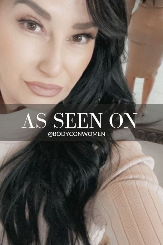 Woman wearing a figure flattering Jane Long Sleeve Bodycon Midi Dress - Classic Black Bodycon Collection