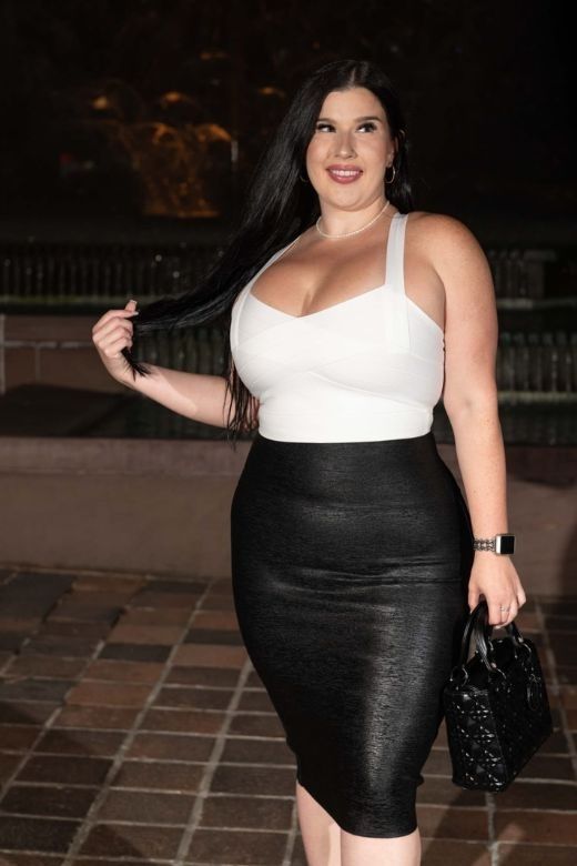 Woman wearing a figure flattering Jay Bandage Top - Classic Black BODYCON COLLECTION