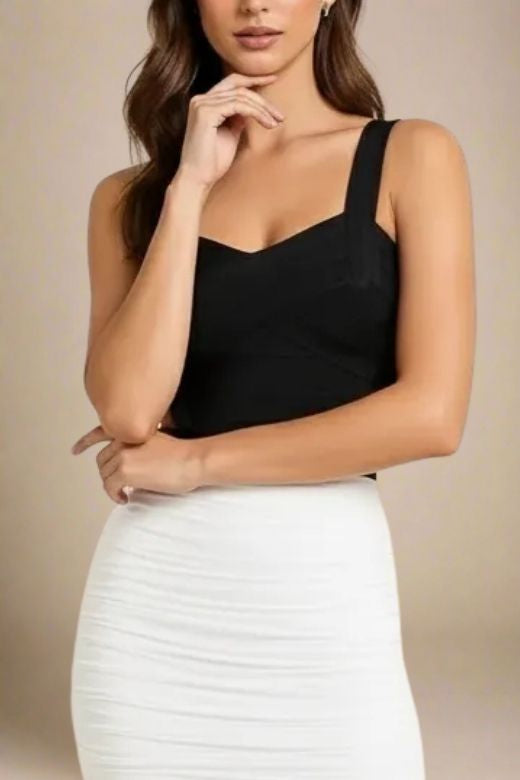 Woman wearing a figure flattering Jay Bandage Top - Classic Black BODYCON COLLECTION