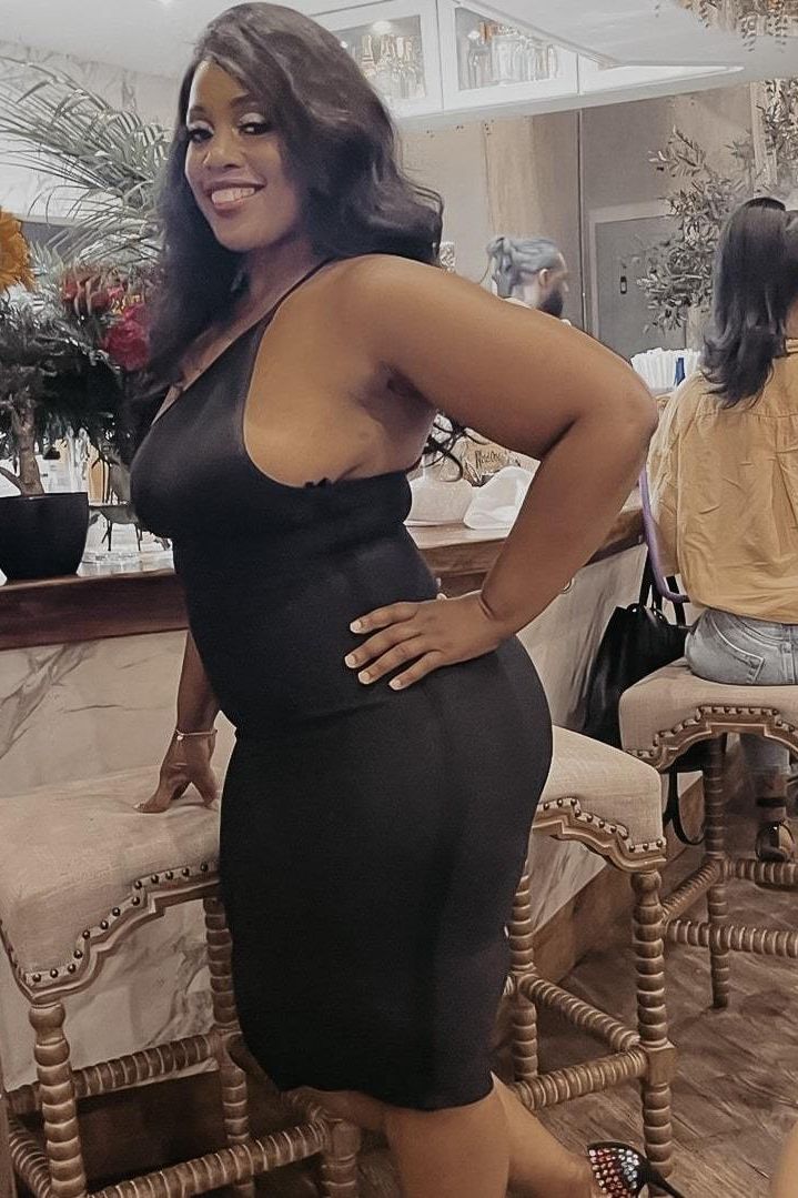 Woman wearing a figure flattering Joi Bodycon Midi Dress - Classic Black Bodycon Collection