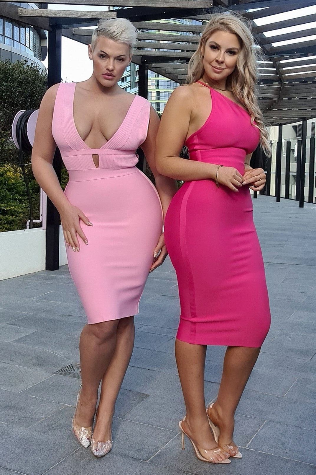 Woman wearing a figure flattering Joi Bodycon Midi Dress - Hot Pink Bodycon Collection