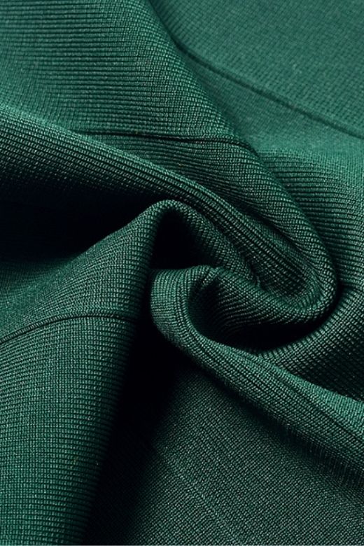 Woman wearing a figure flattering Josie Bandage V Neck Mini Dress - Emerald Green BODYCON COLLECTION