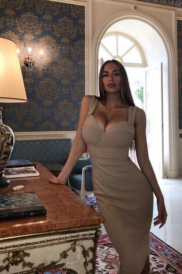 Woman wearing a figure flattering Kate Bandage Dress - Nude Bodycon Collection