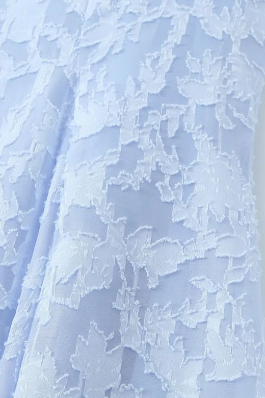 Woman wearing a figure flattering Kora Bodycon Maxi Dress - Baby Blue BODYCON COLLECTION