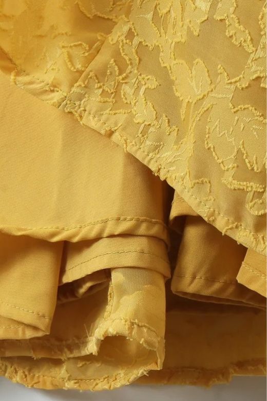 Woman wearing a figure flattering Kora Bodycon Maxi Dress - Lemon Yellow BODYCON COLLECTION