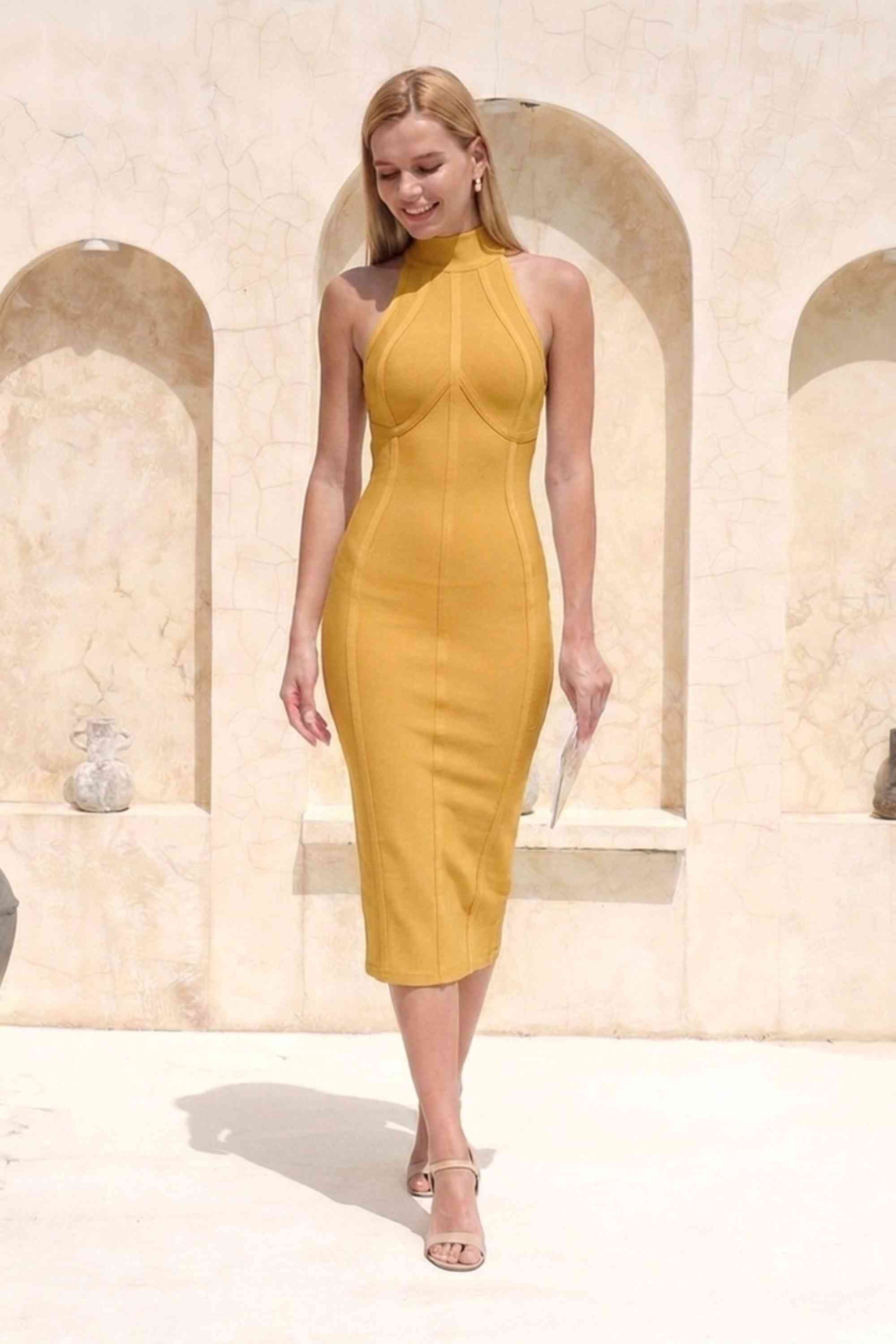 Woman wearing a figure flattering Lea Bandage Midi Dress - Mustard Yellow Bodycon Collection