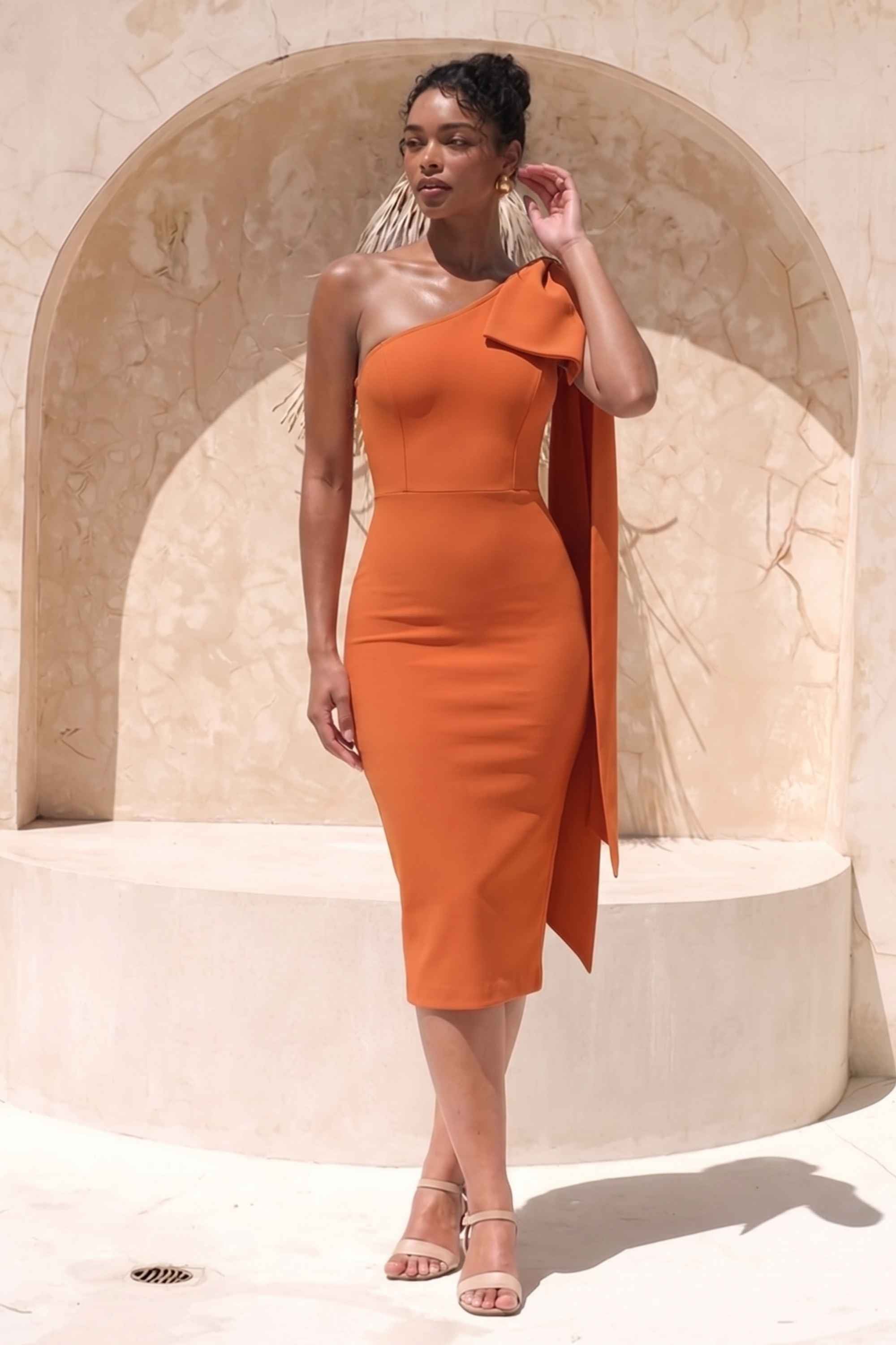 Woman wearing a figure flattering Lela Long Sleeve Bandage Midi Dress - Apricot Orange BODYCON COLLECTION