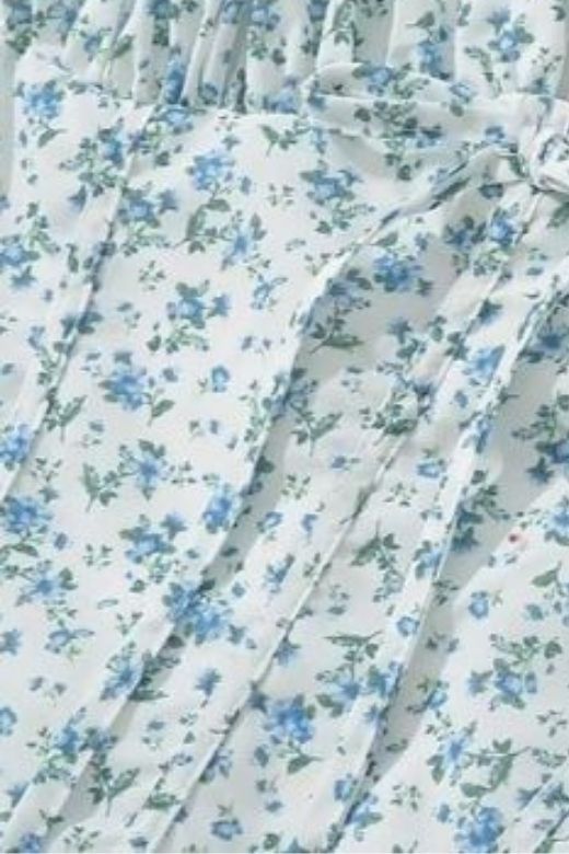 Woman wearing a figure flattering Lynsie Bodycon Midi Dress - Blue Floral BODYCON COLLECTION