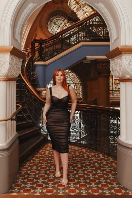 Woman wearing a figure flattering Marilyn Bodycon Wrap Midi Dress - Classic Black BODYCON COLLECTION