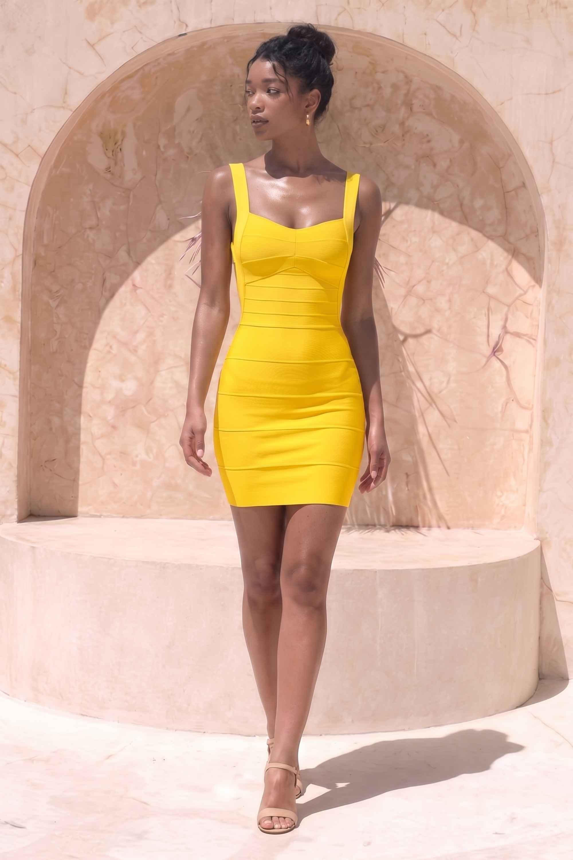 Woman wearing a figure flattering Maya Bandage Mini Dress - Sun Yellow BODYCON COLLECTION