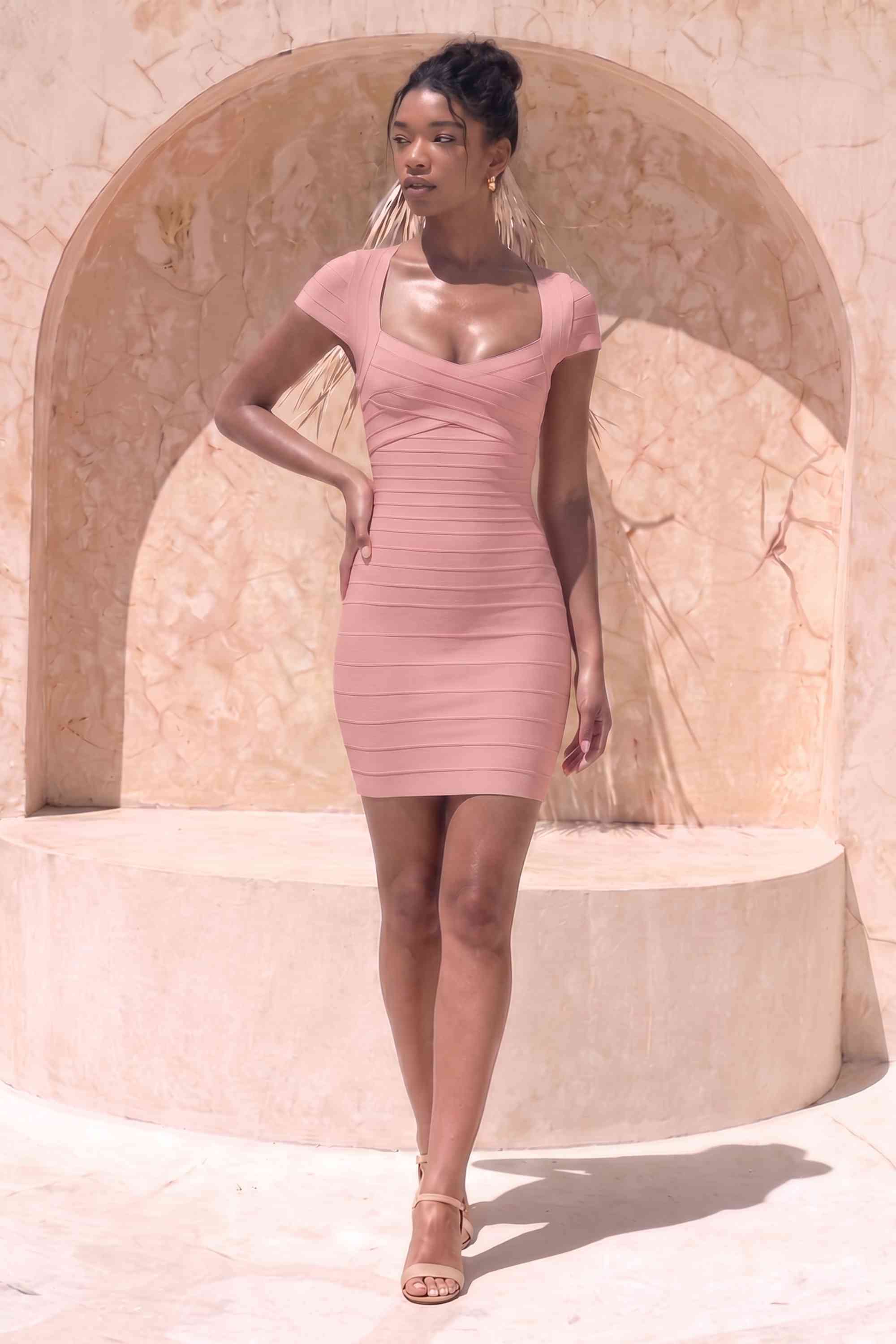 Woman wearing a figure flattering Miranda Bandage Mini Dress - Ballet Pink Bodycon Collection