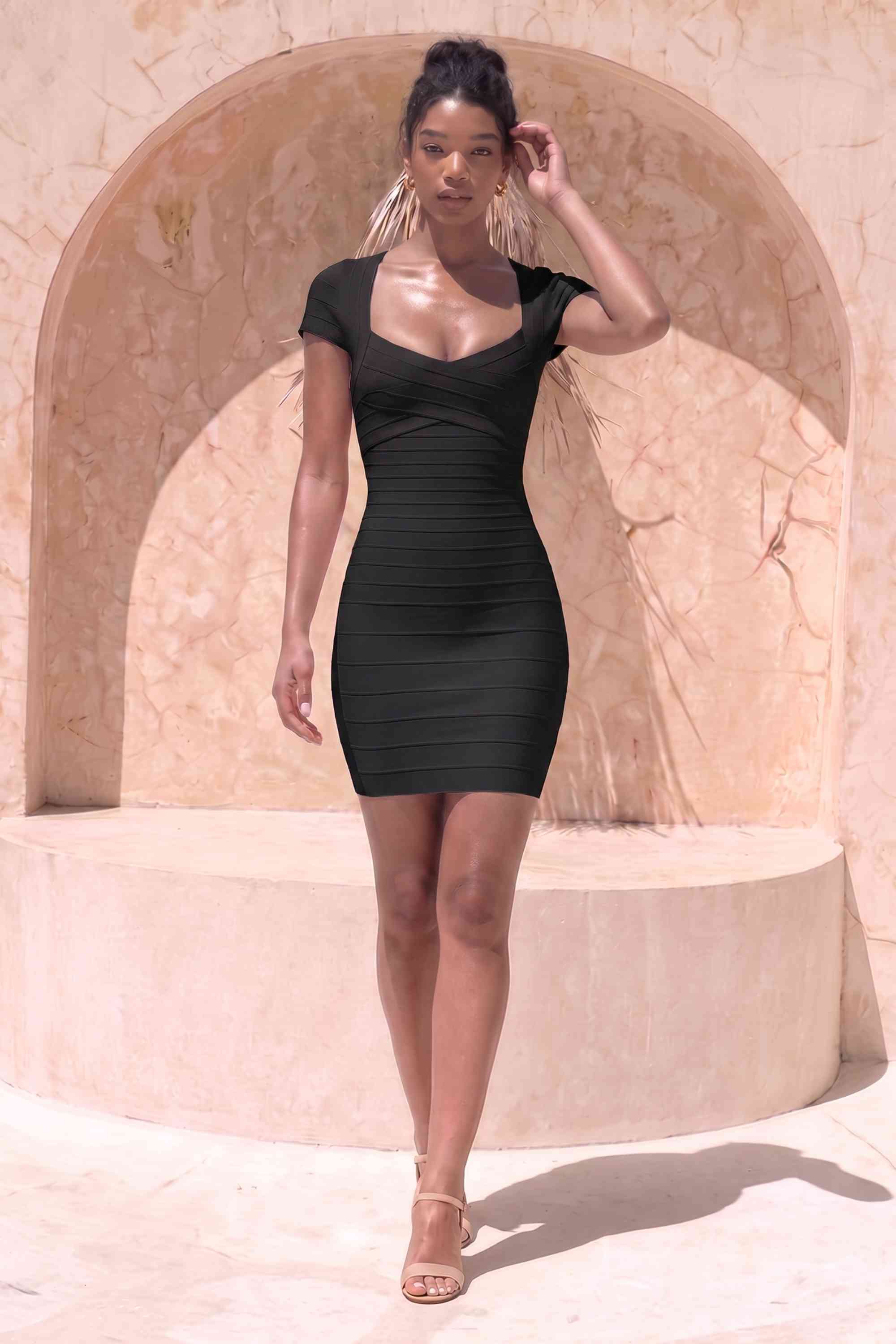 Woman wearing a figure flattering Miranda Bandage Mini Dress - Classic Black Bodycon Collection