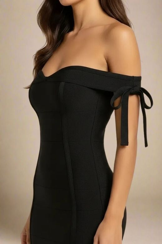 Woman wearing a figure flattering Penelope Bandage Mini Dress - Classic Black BODYCON COLLECTION