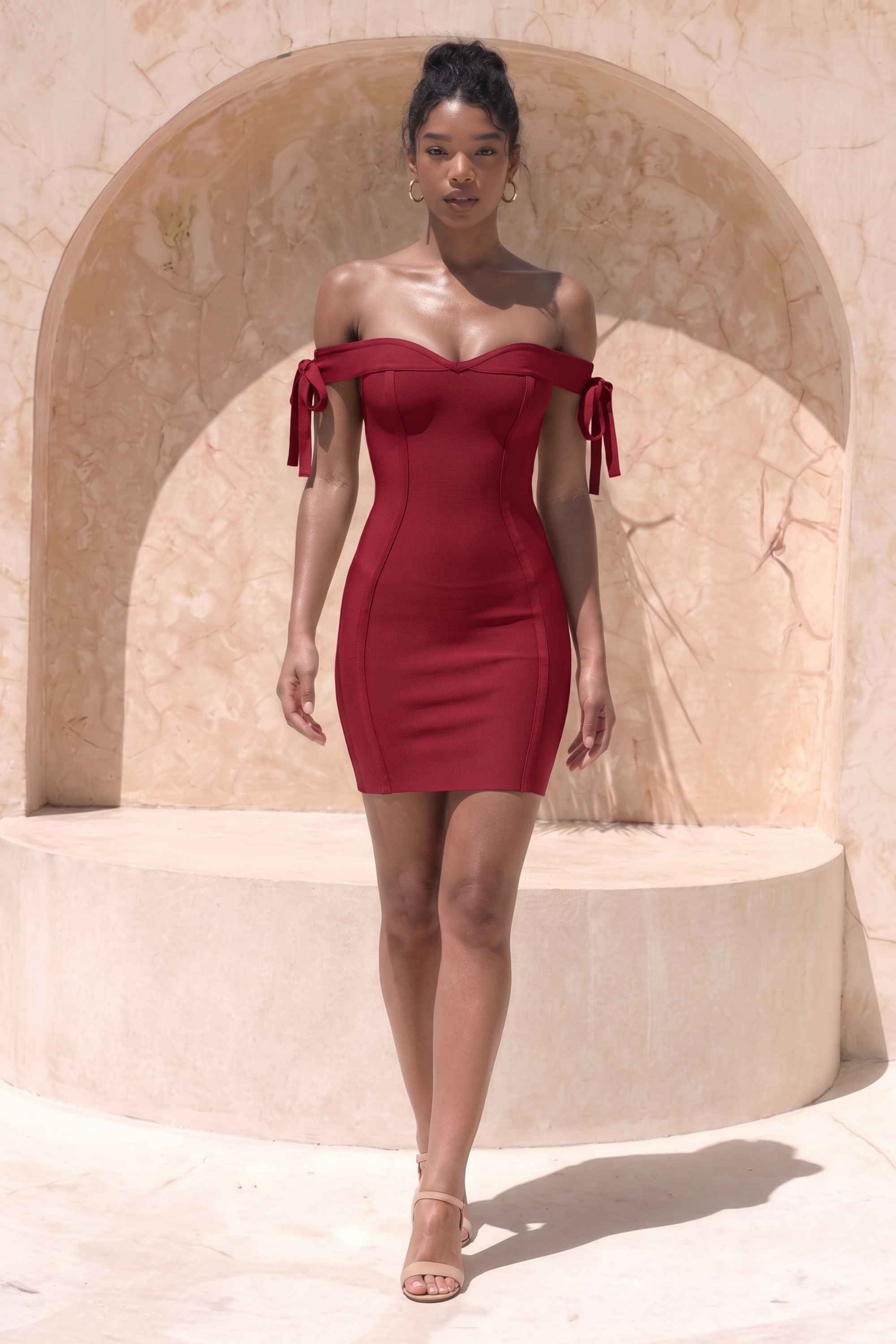 Woman wearing a figure flattering Penelope Bandage Mini Dress - Red Wine BODYCON COLLECTION