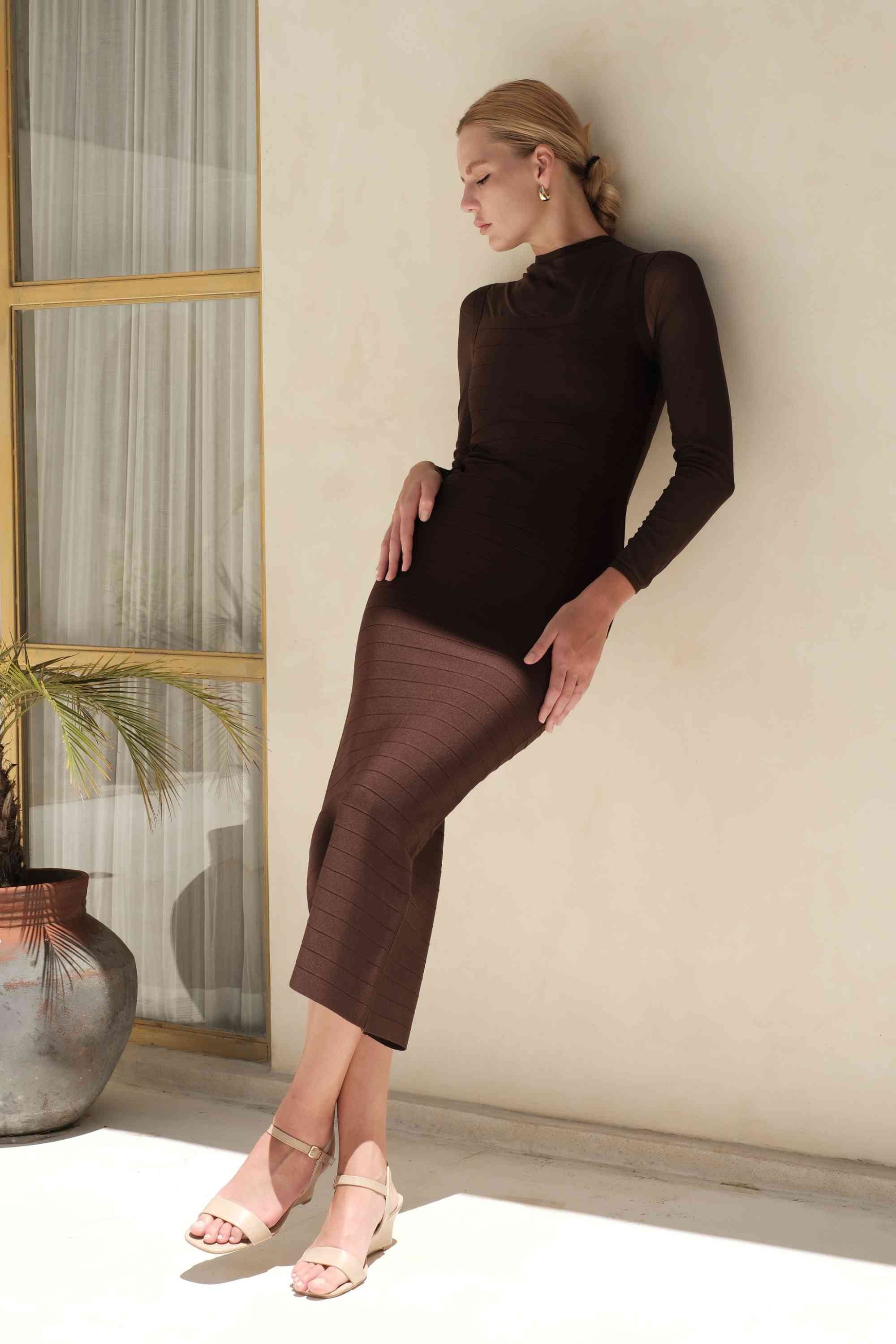 Woman wearing a figure flattering Robin Long Sleeve Bandage Maxi Dress - White Pearl BODYCON COLLECTION Pty Ltd