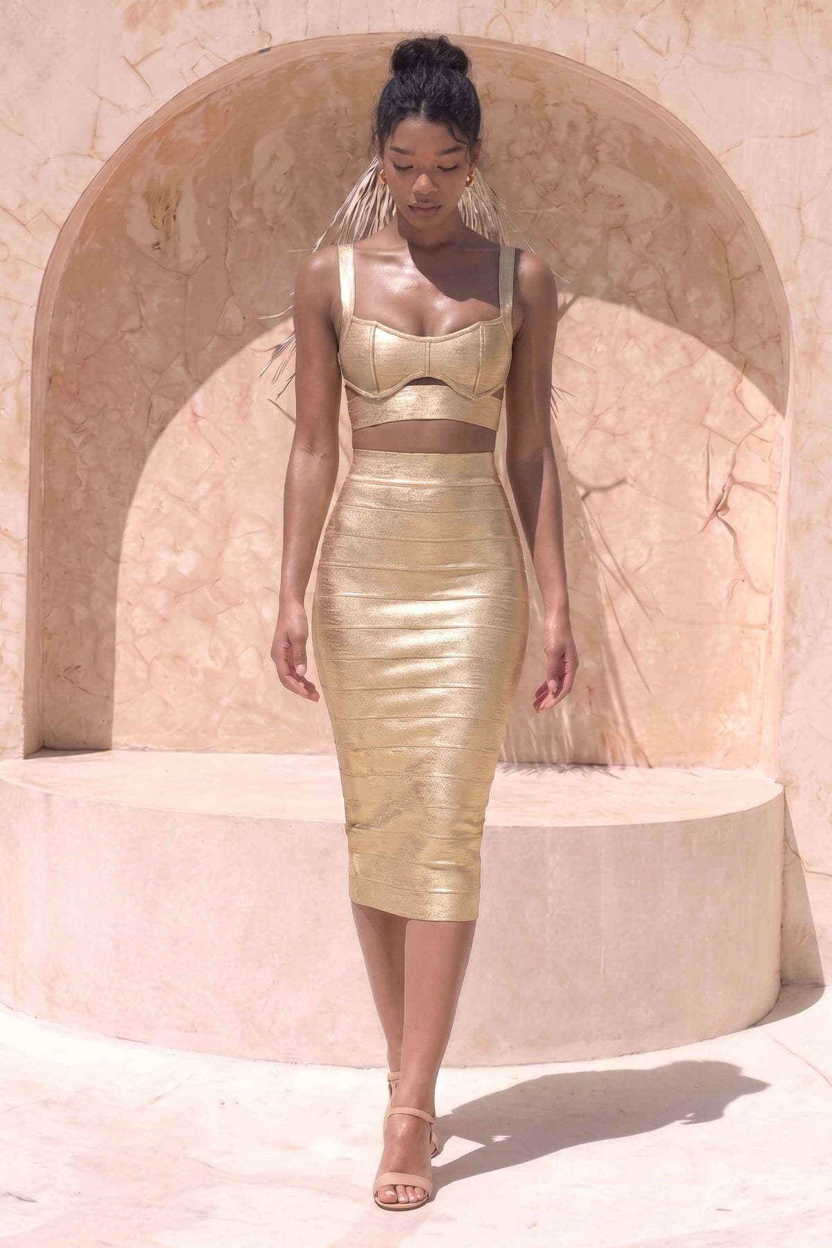 Woman wearing a figure flattering Selene Bandage Crop Top and Midi Skirt Set - Gold BODYCON COLLECTION Pty Ltd