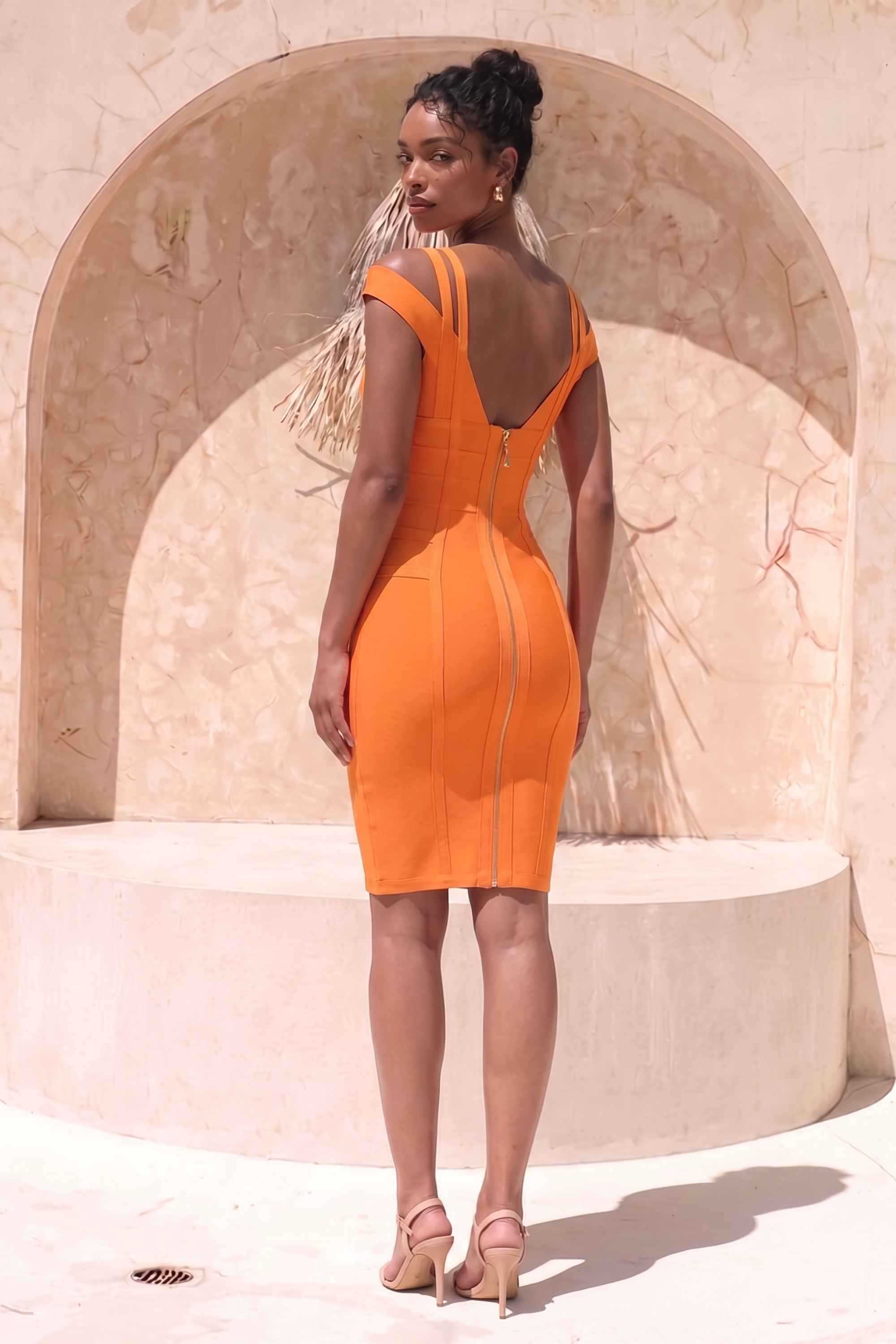 Woman wearing a figure flattering Sia Bandage Dress - Apricot Orange Bodycon Collection