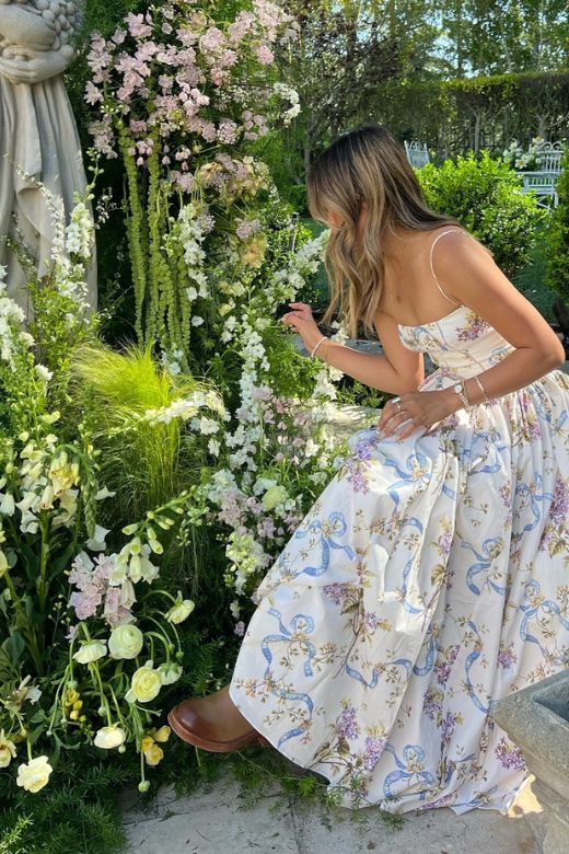 Woman wearing a figure flattering Tasmin Bodycon Midi Dress - White Floral BODYCON COLLECTION