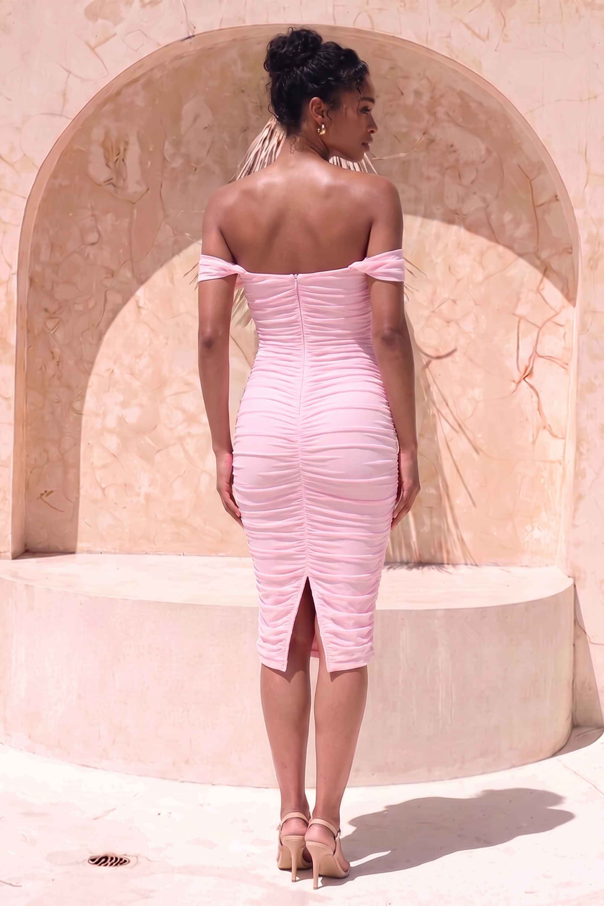 Woman wearing a figure flattering Zia Bodycon Wrap Midi Dress - Dusty Pink Bodycon Collection